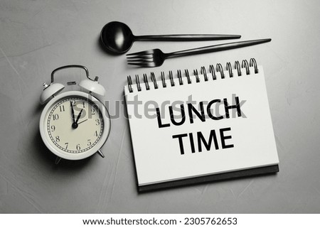 Business lunch. Notebook with phrase Lunch Time, cutlery and alarm clock on light gray table, flat lay Royalty-Free Stock Photo #2305762653