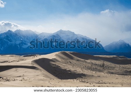 Russia. Beautiful scenery of the northernmost desert in the world. View of the Kodar Ridge. Chara sands. The region of baikaL Kodar National natural park.  Royalty-Free Stock Photo #2305823055