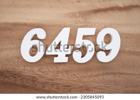 White number 6459 on a brown and light brown wooden background.