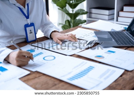 Accountant using calculator and writing on paper, Business woman working audit calculating price taxes loan rates, bookkeeper or financial inspector hand making result Royalty-Free Stock Photo #2305850755