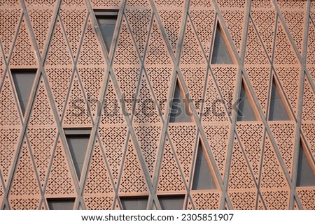 geometric triangle pattern on side of a building, polygonal pattern on a building taken from low angle