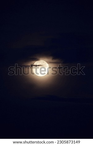 selective focus picture of moon behind clouds