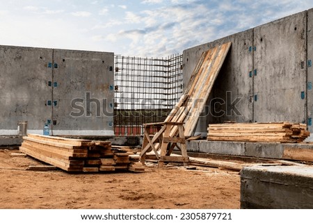 Monolithic reinforced concrete work at the construction site. Boards for the construction of formwork. Erection and reinforcement of reinforced concrete walls of the building Royalty-Free Stock Photo #2305879721