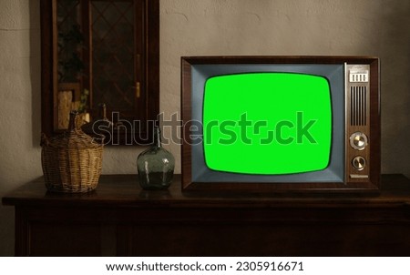 footage of Dated TV Set with Green Screen Mock Up Chroma Key Template Display, Nostalgic living room with furniture and old mirror, Chroma Key, retro style Television, vintage evening tv concept Royalty-Free Stock Photo #2305916671