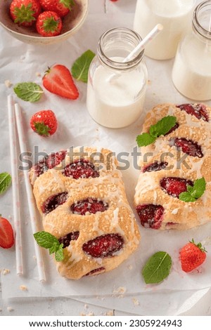 Delicious strawberry yeast cake served with milk. Yeast with strawberries and crumble.