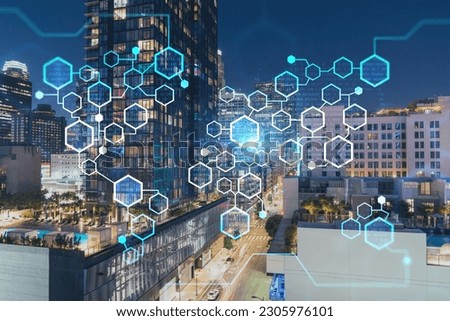 Illuminated cityscape of Los Angeles downtown at summer night time, California, USA. Skyscrapers of panoramic city center of LA. Decentralized economy. Blockchain and cryptography concept, hologram