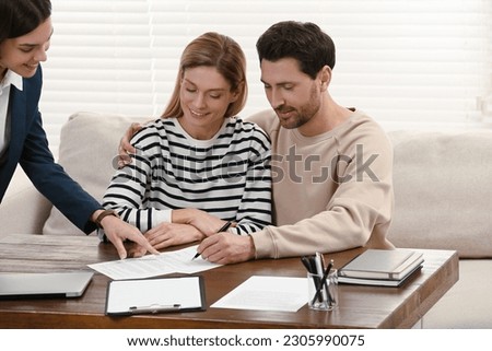 Professional notary working with couple in office
