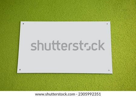 Empty space for a text or photo poster - an advertising and information board with a white background on the wall
