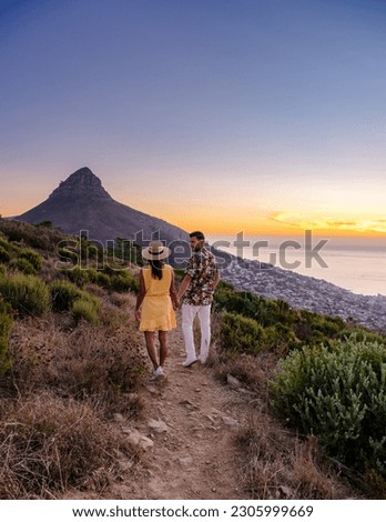 A couple of men and women watching the sunset at Lion's Head near Table Mountain Cape Town South Africa Royalty-Free Stock Photo #2305999669