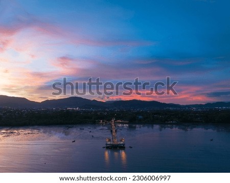 aerial photography cloud above Palai pier at beautiful sunset.
Palai pier is next to Chalong pier.
fishing boats parking on the beach.
colorful cloud above the mountain range background.
