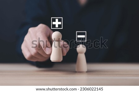 The wooden block shows plus and minus signs. Concepts of opposites, decisions, and uncertainty. Analysis of positive or negative business alternatives. select the plus sign Royalty-Free Stock Photo #2306022145