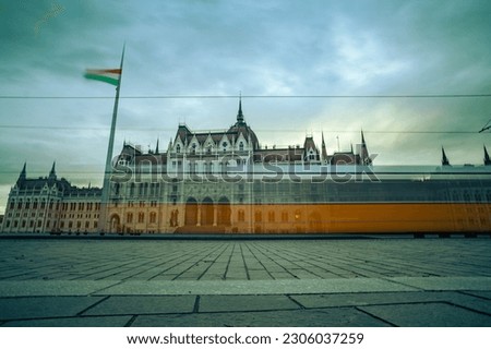 Long exposure of National Assembly with passing tram and hungarian flag, Budapest, Hungary, 2023