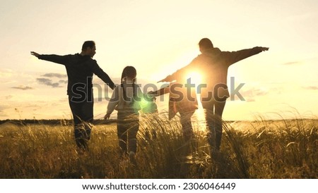 child mother father running sunset. happy family sunny run., child running back view, child runs through field, running spring leisure park, family children run park outdoors, mom dad daughters Royalty-Free Stock Photo #2306046449