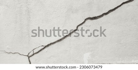 Concrete that cracks buildings or walls leading to obvious crevices. Cracks in the cement wall until a long split is visible. This could be due to improper mortar mix or soil subsidence.  Royalty-Free Stock Photo #2306073479
