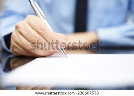 Business man signing the contract to finalize a deal