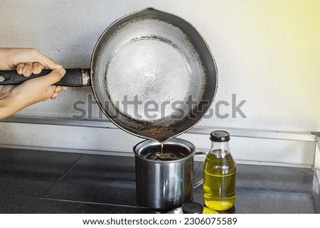 Pour the used cooking oil into the contaminated cooking oil container. Old or used cooking oil can be recycled for biodiesel. But do not reuse it for cooking. May cause carcinogens. Royalty-Free Stock Photo #2306075589