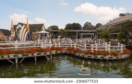 The appearance of a beautiful garden area with a bridge and a pond around it, which is in the Celosia Flower Park Tourism Area, Bandungan, Central Java