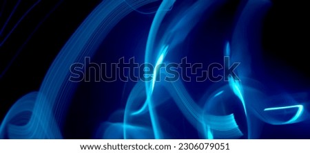 Blue and neon light painting photography, long exposure ripples and waves pattern against a black background. Light trails long exposure highway Blue and gold light painting photography, long exposure
