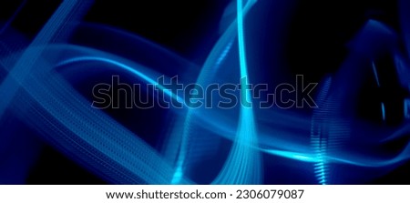Blue and neon light painting photography, long exposure ripples and waves pattern against a black background. Light trails long exposure highway Blue and gold light painting photography, long exposure