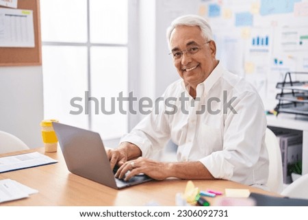 Middle age grey-haired man business worker using laptop working at office Royalty-Free Stock Photo #2306092731