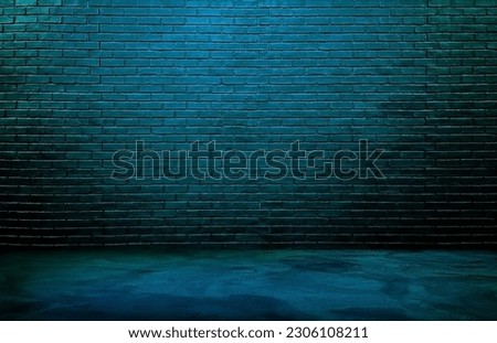 dark black brick wall background, rough concrete and plastered concrete floor, with neon blue glowing lights from above. lighting effect blue and green on empty brick wall background for design.