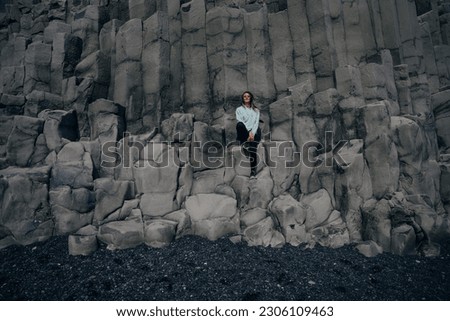 traveler on halsanefshellir cave, Reynisfjara, Iceland. High quality photo