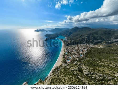 Stunning drone shot revealing the turquoise waters, sandy beaches, and lush hills of Ölüdeniz, Fethiye, Muğla. An illustration of Turkey's charming natural beauty Royalty-Free Stock Photo #2306124969
