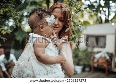 Diverse people portrait of mother with swarthy infant spending time in open air. Multi ethnic family having fun togetherness enjoying motherhood positive emotion motherly care summer vacation in park