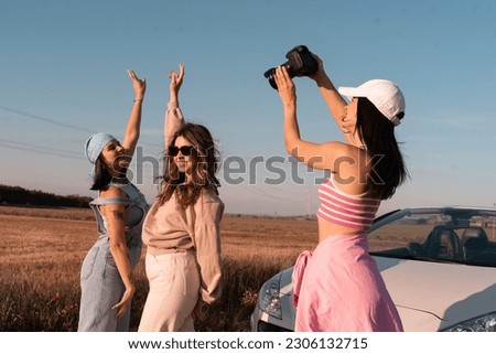 young girls have fun taking pictures and raising their hands while traveling on a summer afternoon.