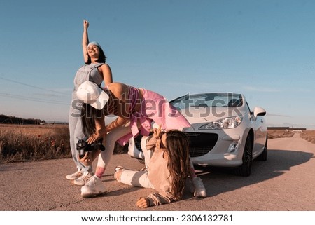 The three young girls have fun and smile taking pictures while traveling on summer vacation.