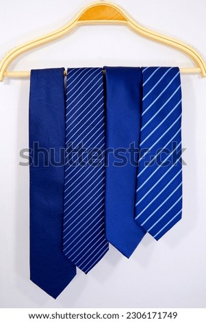 different patterns neck ties hang over white background close up view  Royalty-Free Stock Photo #2306171749