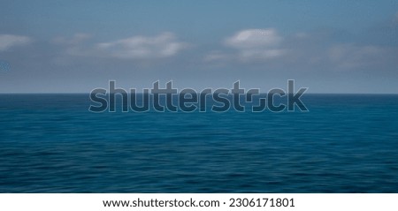 Panoramic seascape with clouds on the horizon. Blurry ocean seascape, serene and peaceful..
