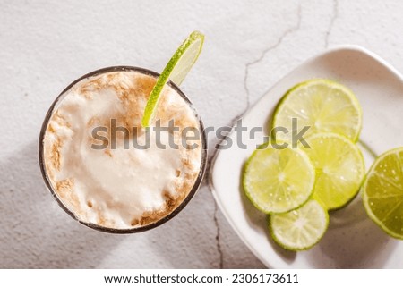Close up of homemade dirty soda with cola and lime in a glass on the table top view