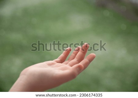 Healthy skin. Close-up of beautiful hand on green natural background. 
