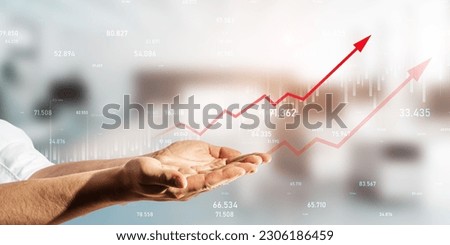Financial goal and sales targeting concept with a male hands presentation virtual economy diagram with red upward arrow on a digital display hologram, on a blurred office background