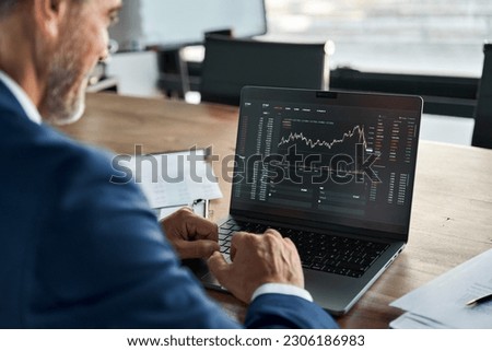 Stock market Investor analyst broker analyzing financial trade crypto stockmarket exchange platform digital chart data on computer screen thinking of investing analytic risk. Over shoulder view. Royalty-Free Stock Photo #2306186983