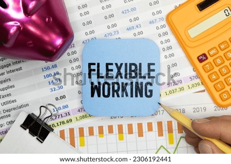 FLEXIBLE WORKING text on craft colored notepad and green plant on the dark background.