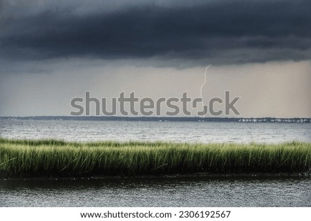 Storm on the ocean, lightning bolt on the ocean, dark storm clouds over water