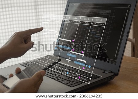 Project manager working with Gantt chart schedule to plan tasks and deliverables. Scheduling activities with a planning software, Corporate strategy for finance, operations, sales, marketing.