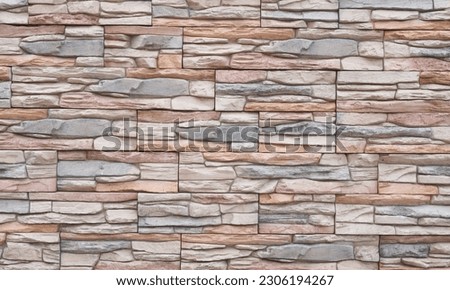 Artificial stone wall with uneven stones. Modern architecture concept idea