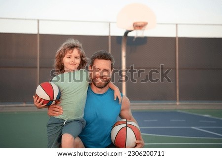 Father and son playing basketball. Family leisure activities concept. Dad and child boy spending time together playing basketball. Sport family.