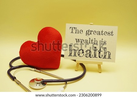 The greatest wealth is Health text message and stethoscope on yellow background