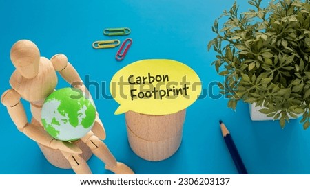 There is notebook with the word Carbon Footprint.It is as an eye-catching image.