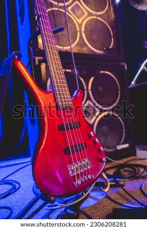 Electric symphony: striking red electric bass in stage before show