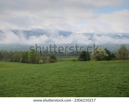 Rolling Country Hills and Low Cloud Mountains