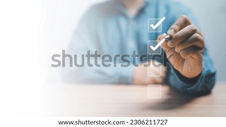 Businessman use pen to tick correct sign mark in checkbox for quality document control checklist and business approve project concept. Royalty-Free Stock Photo #2306211727