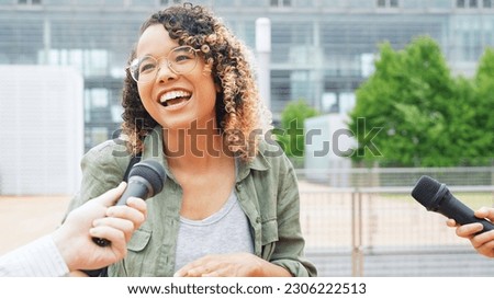 African woman being interviewed on the street by the media. Royalty-Free Stock Photo #2306222513