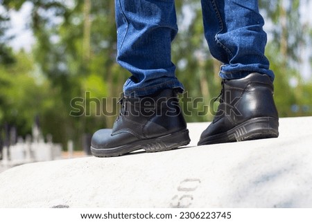 Wear safety shoes to ensure safety at work. construction workers wear safety shoes. People with factory safety concept Royalty-Free Stock Photo #2306223745