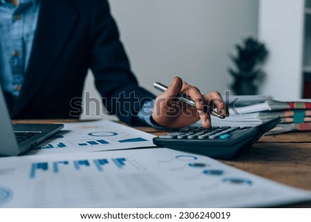 Young asian male work with financial papers at home count on calculator before paying taxes receipts online, planning budget glad to find chance for economy saving money, audit concepts Royalty-Free Stock Photo #2306240019