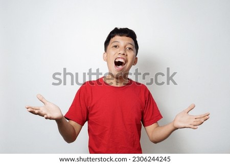 excited Asian mature man wearing red t-shirt isolated by white background